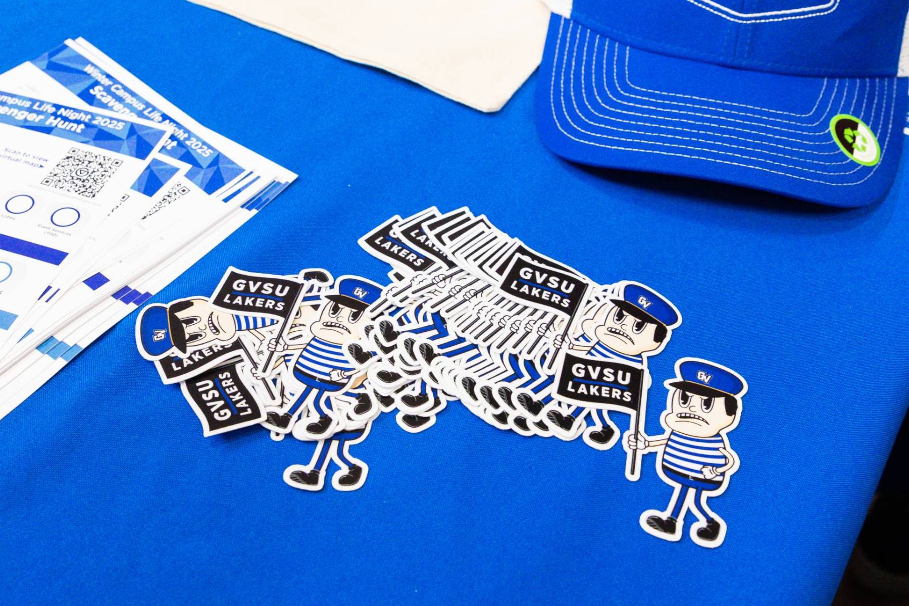 Stickers shaped like Louie the Laker displayed on a table